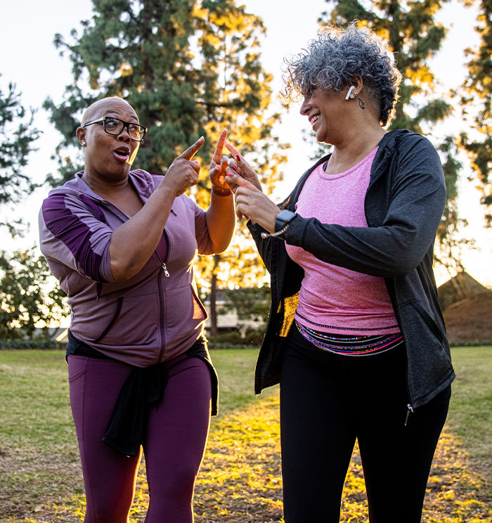 ACE Behavior Change Specialist motivating an enthusiastic client during an outdoor walk