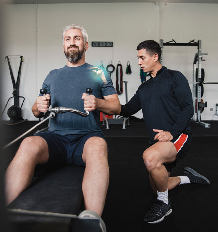 ACE Corrective Exercise Specialist helping client improve shoulder function